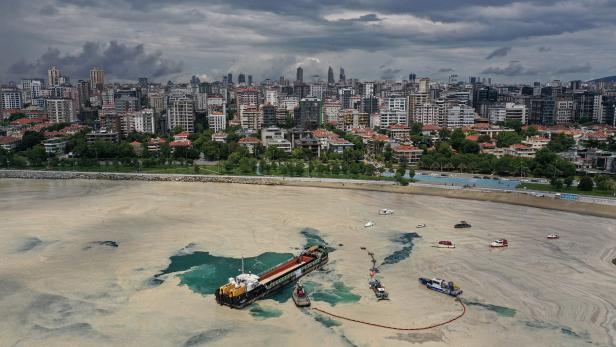 Sea-surface-cleaning vessels and barrier-laying boats of Istanbul Municipality clean up the sea snot in Istanbul
