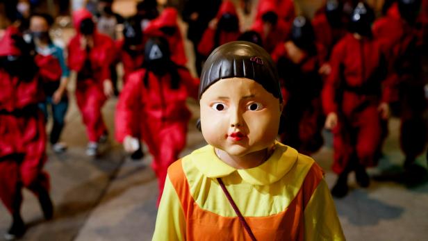 People wear Netflix series 'Squid Game' costumes celebrating Halloween, in Hong Kong