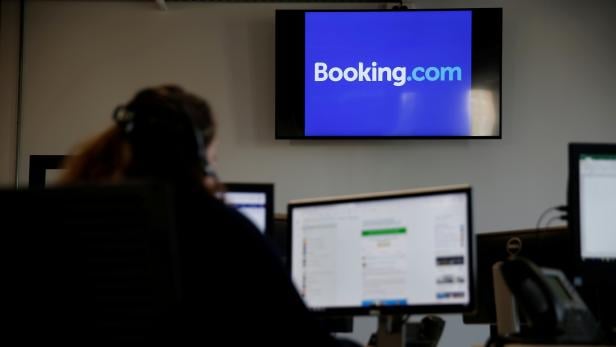 FILE PHOTO: An employee works on his computer at the new Booking.com customers site in Tourcoing