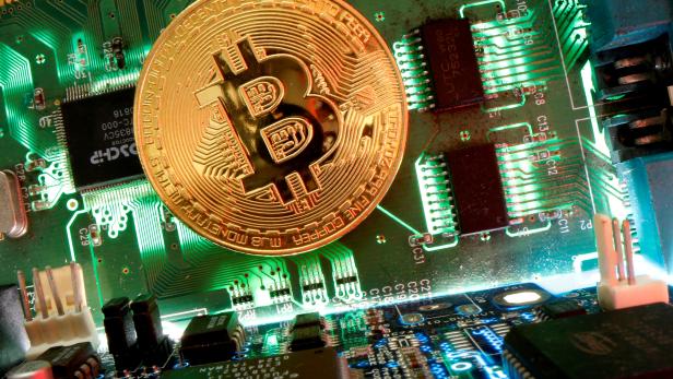 FILE PHOTO: Representation of the virtual currency bitcoin is seen on a motherboard in this picture illustration