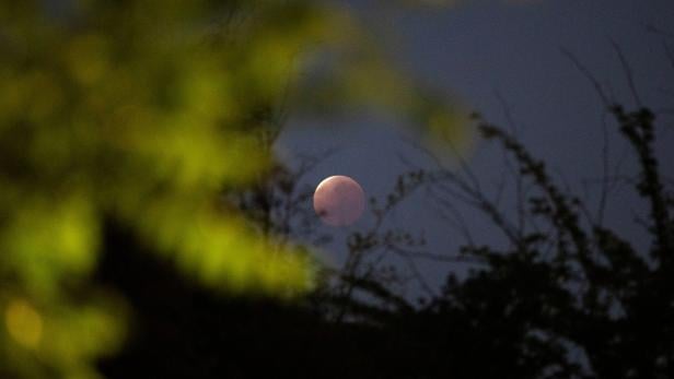 A partial lunar eclipse dubbed the 'blood moon' is seen in Santiago