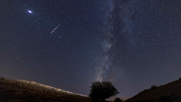 A meteor streaks past stars in the night sky during the annual Perseid meteor shower at the Negev Desert