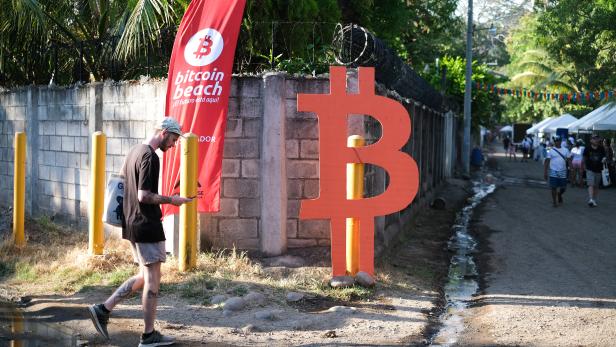 People participate in a meet up between local bitcoin users and foreigners at the closing of Adopting Bitcoin - A Lightning Summit in El Salvador at El Zonte Beach, in Chiltiupan