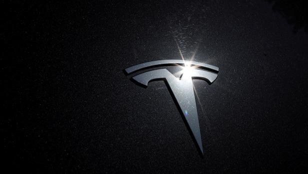 FILE PHOTO: The Tesla logo is seen on a car in Los Angeles