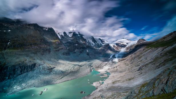 glacier with lagoon and pasterze in austrian mountains showing effects of climate change