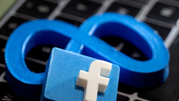 FILE PHOTO: 3D-printed images of Facebook's logo and Meta Platforms seen on a keyboard in this illustration
