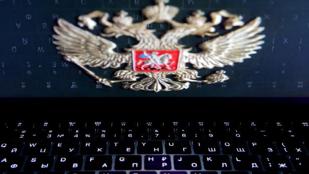 FILE PHOTO: The coat of arms of Russia is reflected in a laptop screen in this picture illustration