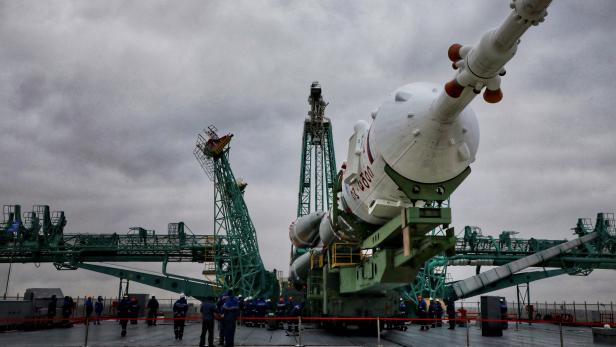 The Soyuz-2.1a rocket booster with the Soyuz MS-21 spacecraft is rolled out onto the launchpad at the Baikonur Cosmodrome