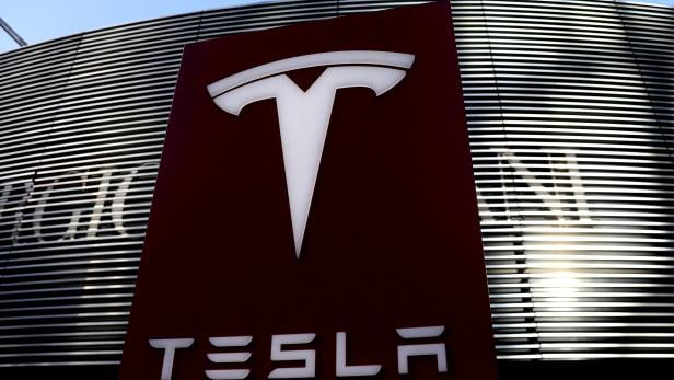 FILE PHOTO: Logo of the electric-vehicle maker Tesla is seen near a shopping complex in Beijing