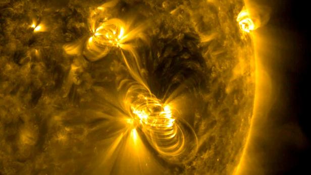 FILE PHOTO: NASA image of a medium-sized (M2) solar flare and a coronal mass ejection (CME) erupting from the same, large active region of the sun