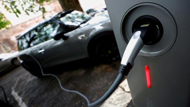 FILE PHOTO: An electric car is plugged in at a charging point for electric vehicles in Rome