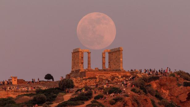 Flower Moon rises behind the Temple of Poseidon, before a lunar eclipse in Cape Sounion