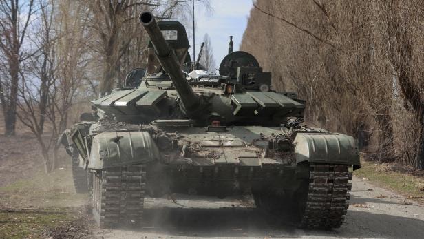 FILE PHOTO: Ukrainian service member drives a captured Russian T-72 tank in Lukianivka