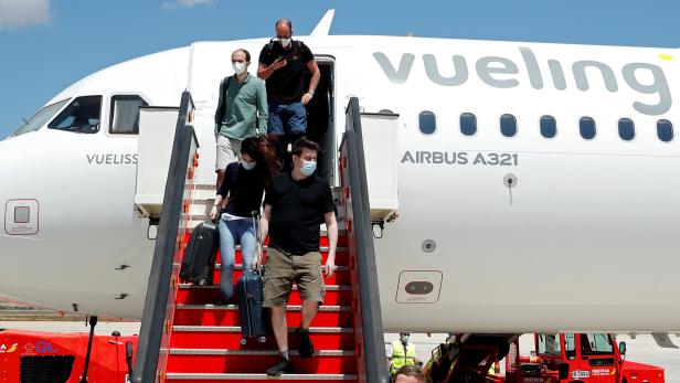 Passengers leave a Vueling plane upon their arrival at Palma de Mallorca airport on the Balearic Islands