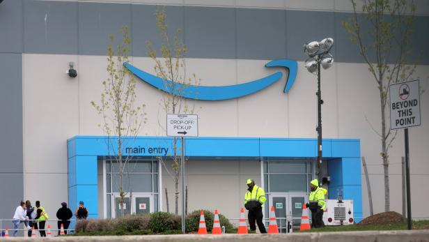 Security personnel are seen as Amazon workers gather outside Amazons LDJ5 sortation center in Staten Island, New York