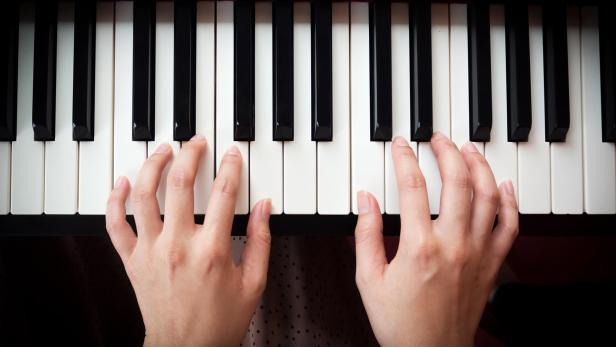 Woman's hand playing piano.