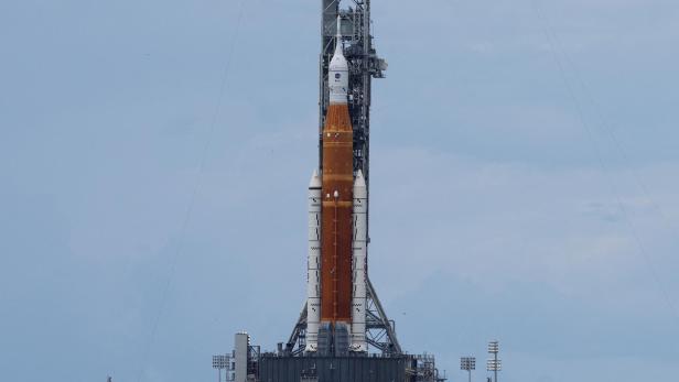NASA's next-generation moon rocket, the Space Launch System (SLS) rocket with its Orion crew capsule perched on top, stands on  launch pad 39B at Cape Canaveral,