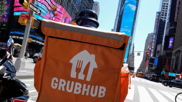 FILE PHOTO: FILE PHOTO: A Grubhub delivery person rides in Manhattan, New York City