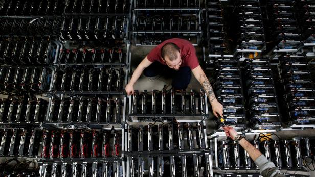 FILE PHOTO: Employees work on bitcoin mining computers at Bitminer Factory in Florence