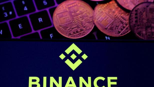 FILE PHOTO: Illustration shows Binance logo and representation of cryptocurrencies