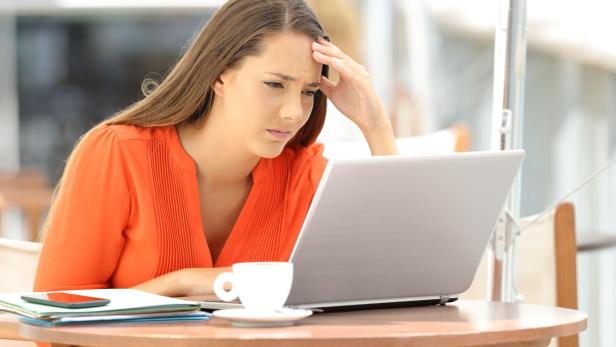 Worried entrepreneur reading bad news on line
