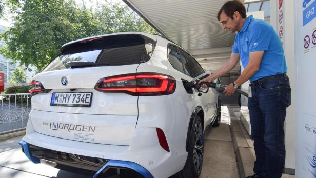 Juergen Guldner, a vice president at BMW in charge of the carmaker's hydrogen car program, fuels a hydrogen fuel-cell prototype SUV at a petrol station in Munich