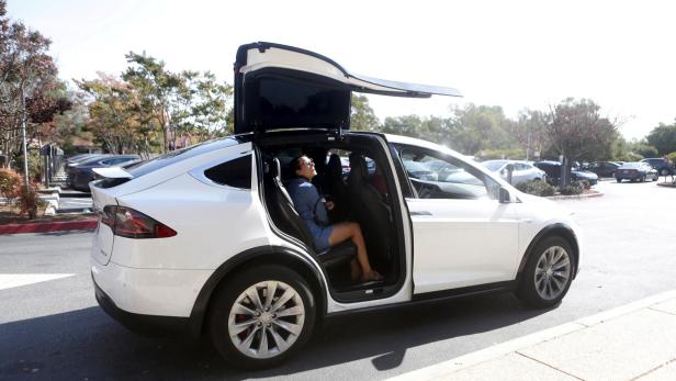 FILE PHOTO: A Tesla Model X picks up passengers during a Tesla event in Palo Alto, California