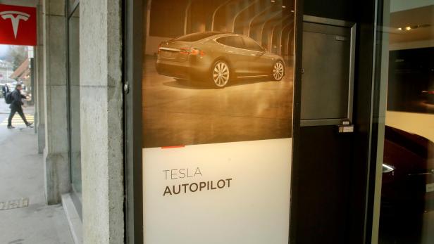 FILE PHOTO: Advertisement promotes Tesla Autopilot at a showroom of U.S. car manufacturer Tesla in Zurich