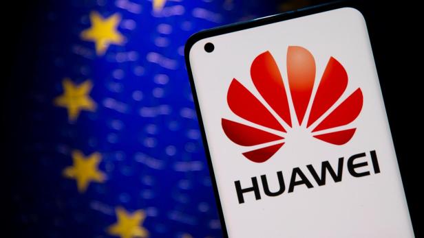 Smartphone with a Huawei logo is seen in front of E.U. flag in this illustration
