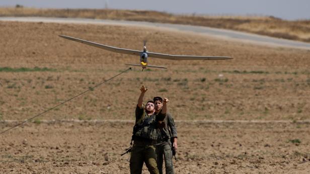 Israeli soldiers fly a drone near the Israel-Gaza border, in Israel