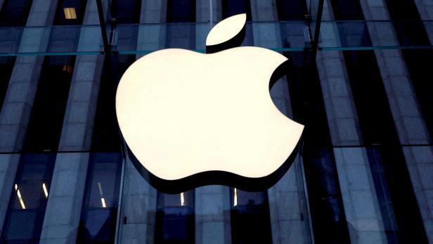 FILE PHOTO: The Apple logo is seen hanging at the entrance to the Apple store on 5th Avenue in Manhattan