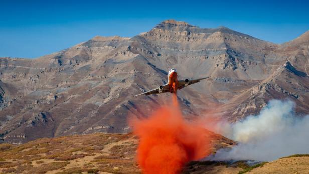 Ein Löschflugzeug bringt einen Löschhemmer aus.