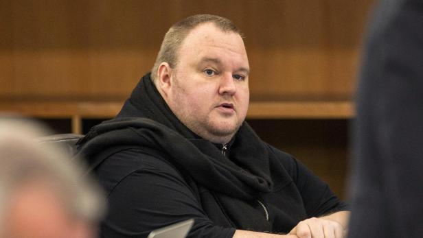 FILE PHOTO: German tech entrepreneur Kim Dotcom sits in a chair during a court hearing in Auckland, New Zealand