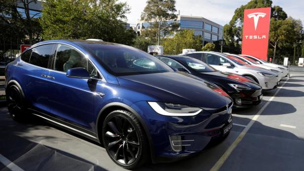 FILE PHOTO: A Tesla Model X car (front) and Model S (2nd L) are photographed at a Tesla electric car dealership in Sydney