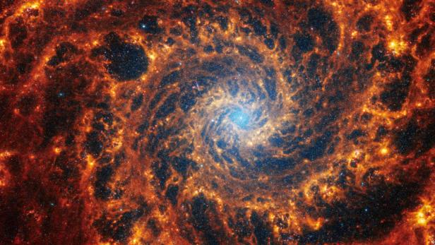 FILE PHOTO: Spiral galaxy NGC 628, located 32 million light-years away from Earth, is seen in an image from the James Webb Space Telescope