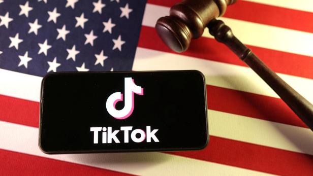 Illustration shows U.S., Chinese flags, TikTok logo and gavel