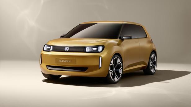 Der goldfarbene Volkswagen ID.Every1 steht vor einem neutralen Hintergrund.