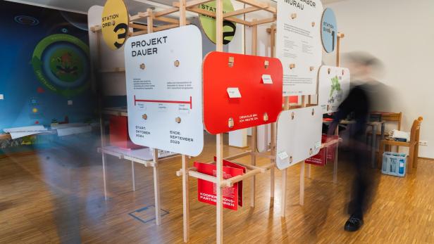 Interaktive Ausstellung mit Infotafeln zum Reallabor Murau und zur Energiewende in einem Raum.