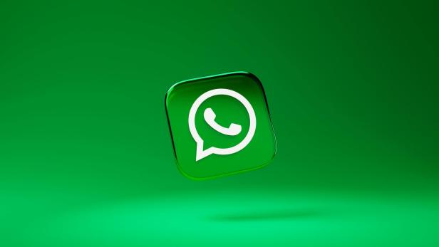 WhatsApp-Logo vor grünem Hintergrund.