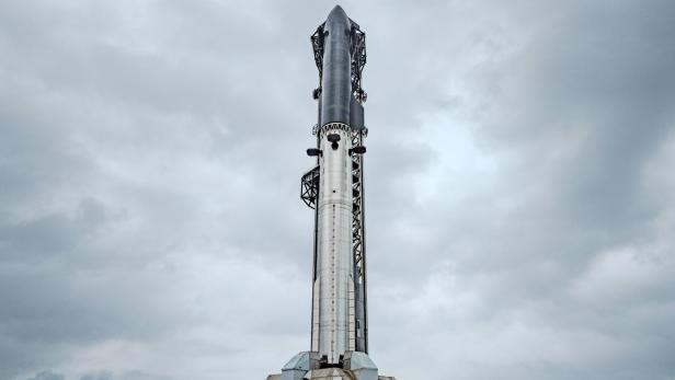 Die Starship-Rakete steht aufrecht auf der Startrampe unter bewölktem Himmel.