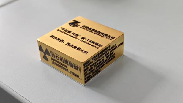 Rendering einer gelben, viereckigen Atombatterie mit der Aufschrift Qianjiyuan Tianshu liegt auf einem weißen Tisch