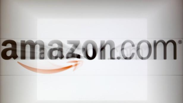 A zoomed image of a computer screen showing the Amazon logo is seen in Vienna in this November 26, 2012, file photo. Amazon.com Inc reported a second-quarter net loss and issued cautious third-quarter forecasts on July 25, 2013, pressuring shares of the world&#039;s largest Internet retailer. REUTERS/Heinz-Peter Bader/Files (AUSTRIA - Tags: POLITICS BUSINESS)