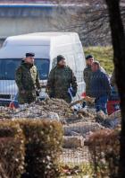 Police and military officers stand at a drone crash site, following Russia's invasion of Ukraine, in Zagreb