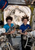 U.S. astronauts Jessica Meir and Christina Koch pose in the International Space Station