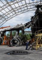 Employees work near the world's biggest aircraft Antonov An-225 Mriya, destroyed by Russian troops, at an airfield in the settlement of Hostomel
