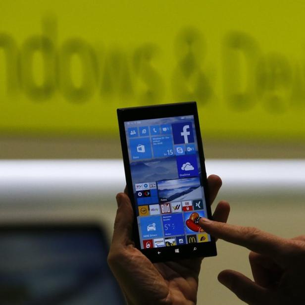 Eine Person bedient ein Windows Phone mit verschiedenen Apps auf dem Bildschirm.