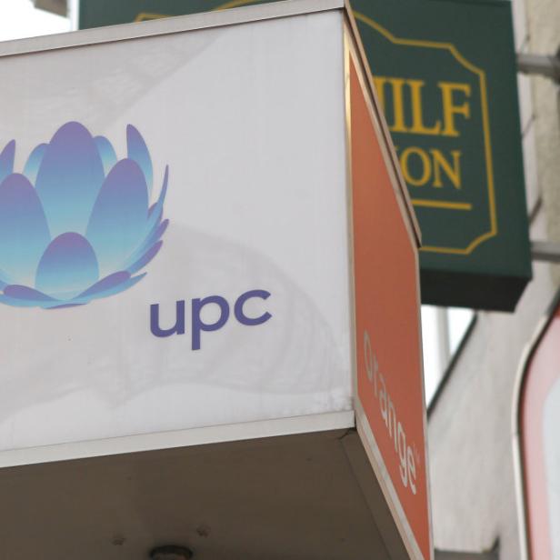 Ein Schild mit dem UPC-Logo und einem stilisierten blauen Lotusblüten-Symbol.