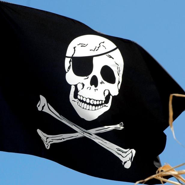 Jolly Roger &quot;Jolly Roger&quot;, auch &quot;Black Jack&quot; genannt, ist die charakteristische Totenkopfflagge der Piraten. Darauf befindet sich ein Totenschädel über zwei gekreuzten Säbeln oder Knochen. Dem modernen Pirat ist die Flagge vor allem als Markenzeichen des Hamburger Fußballvereins St. Pauli bekannt.