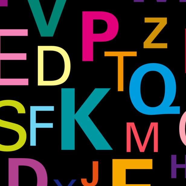 Ein farbenfrohes Durcheinander von Buchstaben auf schwarzem Hintergrund.