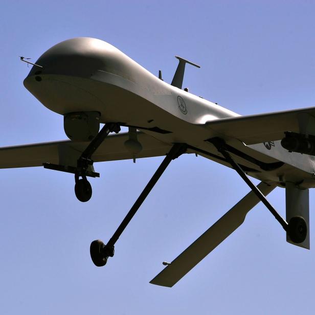 Eine unbemannte Luftdrohne fliegt vor blauem Himmel.